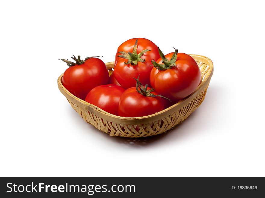 Fresh tomato in a basket isolated on white background. Fresh tomato in a basket isolated on white background