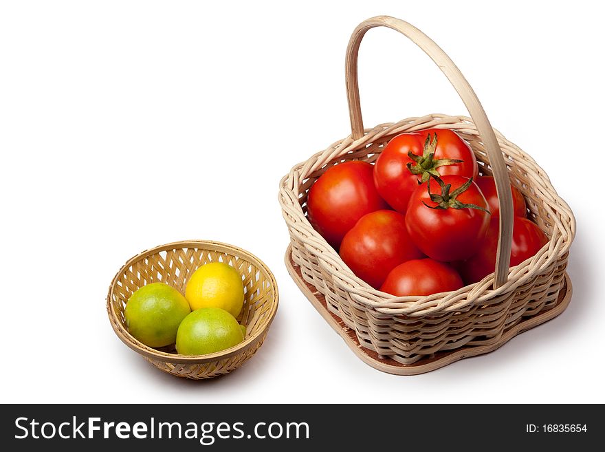 Fresh tomato and lemon in a basket isolated on white background. Fresh tomato and lemon in a basket isolated on white background