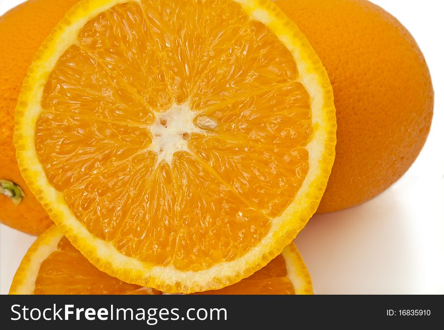 Close up capturing a selection of whole and halved fresh oranges over white. Close up capturing a selection of whole and halved fresh oranges over white.