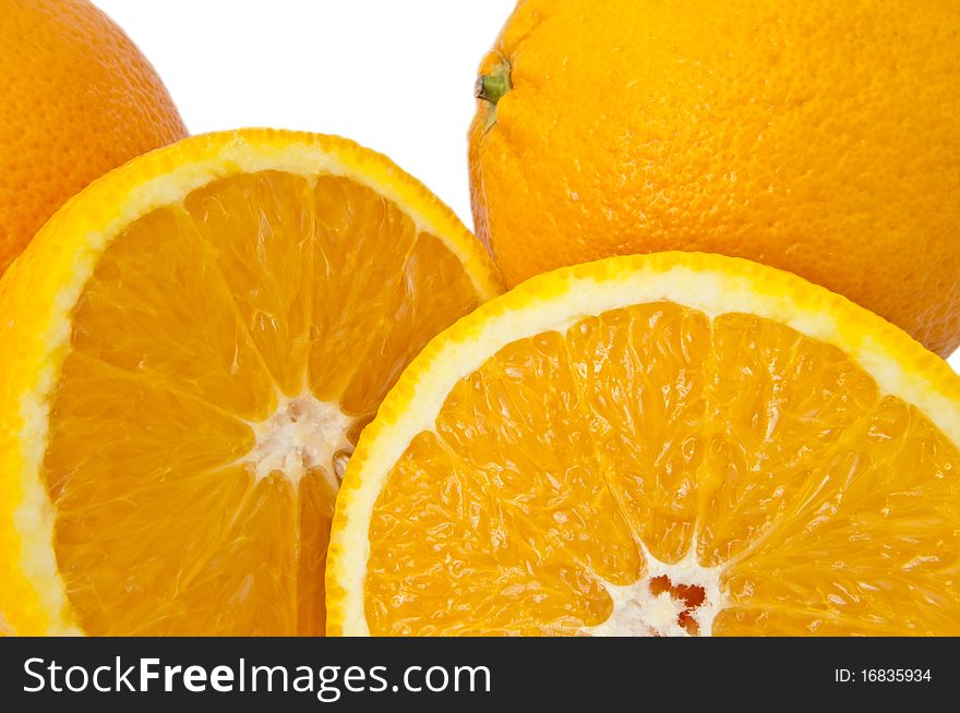 Close up of whole and cut oranges arranged over white. Close up of whole and cut oranges arranged over white.