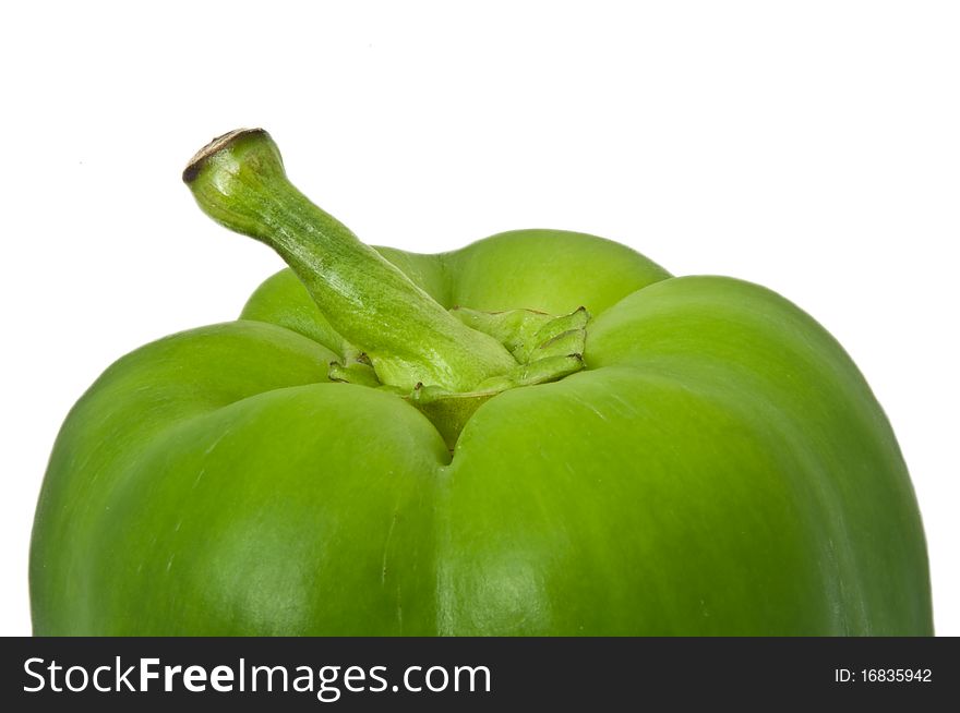Close up capturing the top portion of a green bell pepper with white background. Close up capturing the top portion of a green bell pepper with white background.