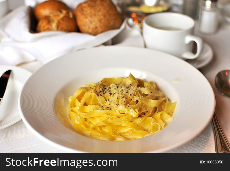 Tasty Italian style fettuccine cooked in cream sauce with luxurious table layout. Tasty Italian style fettuccine cooked in cream sauce with luxurious table layout.