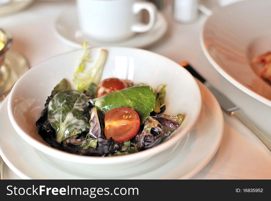 Vegetarian salad prepared with various vegetables and topped with salad cream.