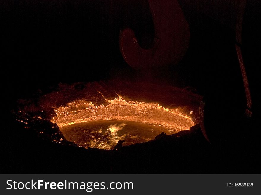 Melted steel in pot, inside steel factory. Melted steel in pot, inside steel factory