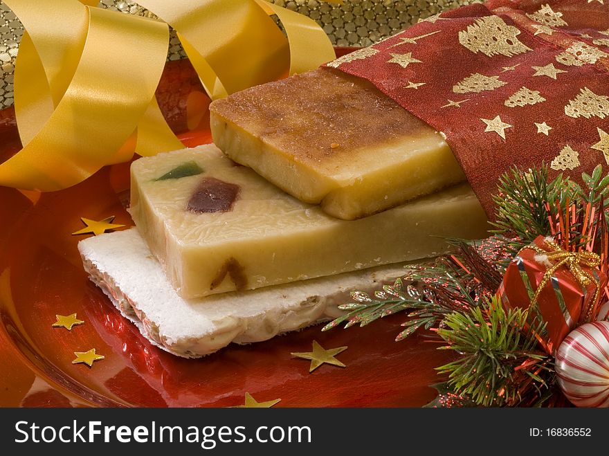 Typical Spanish Christmas nougat in a red plate