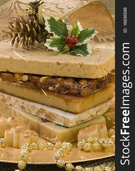 Typical Spanish Christmas nougat in a golden plate