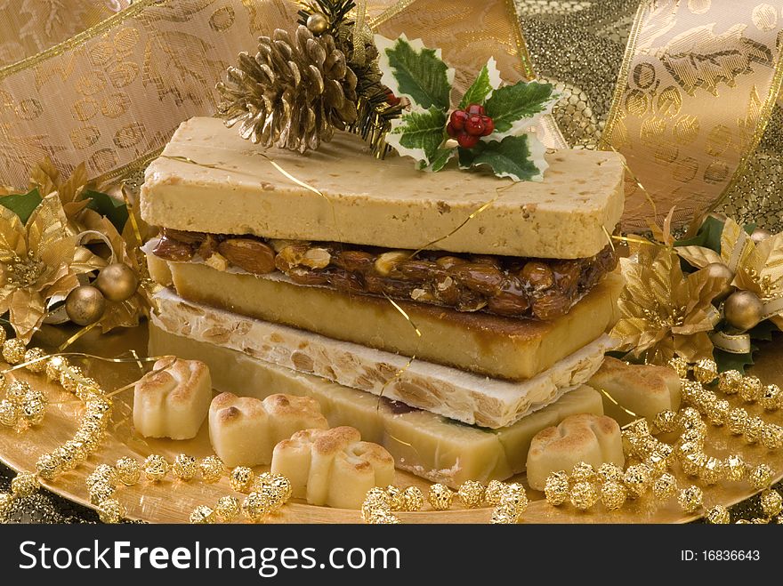 Typical Spanish Christmas nougat in a golden plate