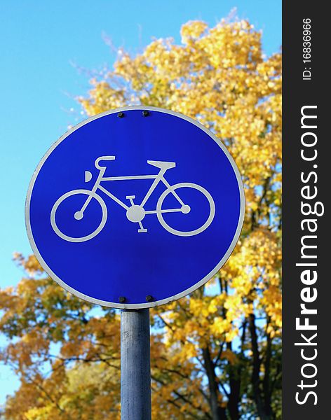 Sign showing bike on background of blue sky and yellow trees in Germany. Sign showing bike on background of blue sky and yellow trees in Germany