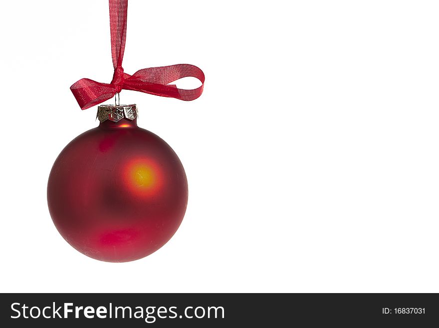 Red Christmas bauble on a white background hanging on a red ribbon. Red Christmas bauble on a white background hanging on a red ribbon