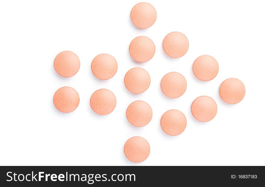 Close-up of orange pills arrow, isolated on white. Close-up of orange pills arrow, isolated on white.