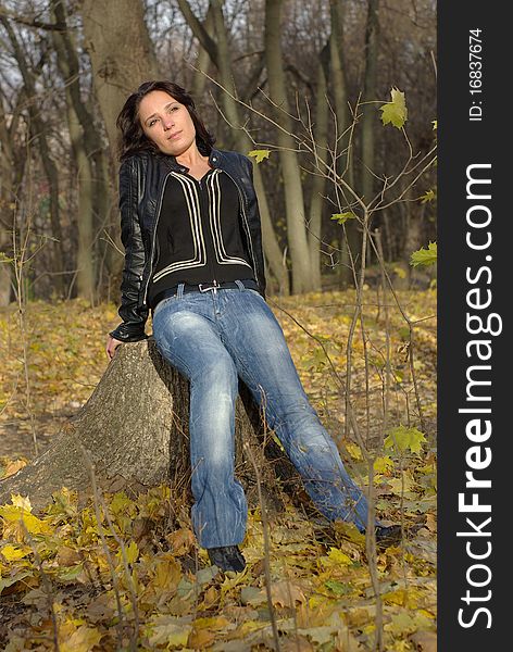 Girl sitting on a tree stump. Girl sitting on a tree stump