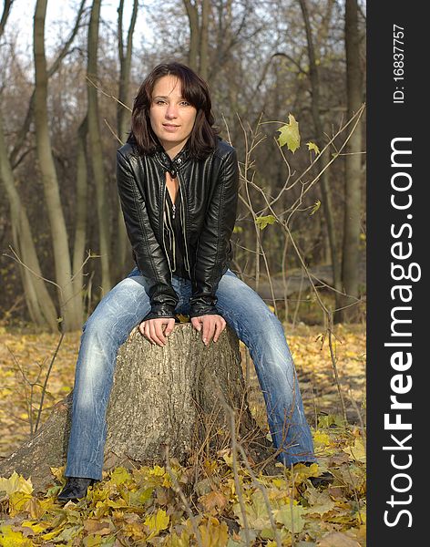 Girl sitting on a tree stump. Girl sitting on a tree stump