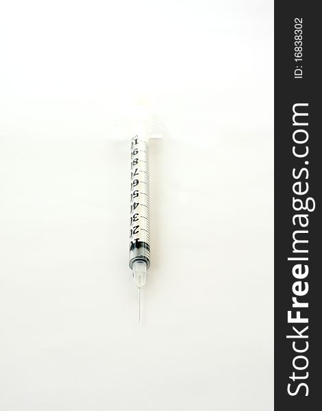 Small hypodermic syringe for patient. On white paper. Small hypodermic syringe for patient. On white paper.