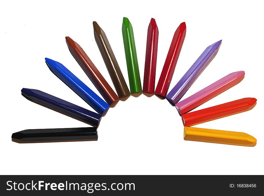 Used colored wax crayons isolated on white background