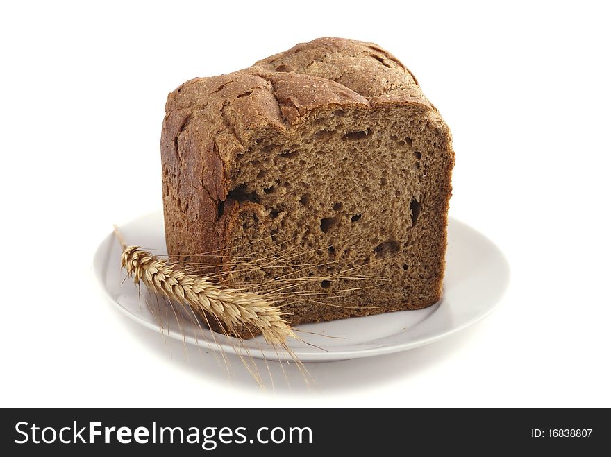 Homemade sliced bread on a plate on white background. Homemade sliced bread on a plate on white background