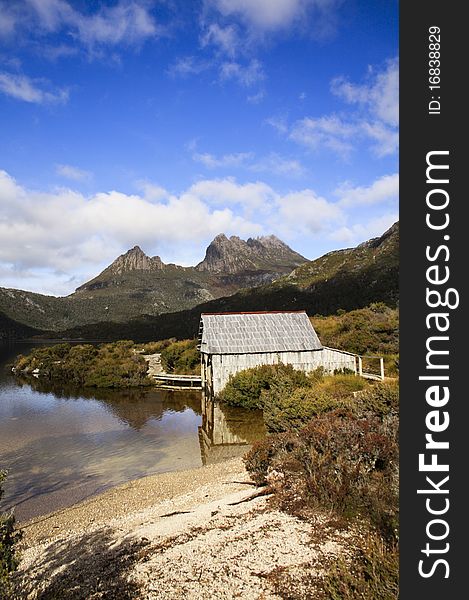 This photo was taken on a mountain in Tasmania. Beautiful landscape with sky, clouds, mountain, lake and a small log cabin. beautiful as a painting. This photo was taken on a mountain in Tasmania. Beautiful landscape with sky, clouds, mountain, lake and a small log cabin. beautiful as a painting.