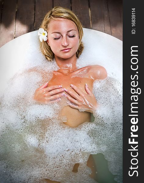 Young woman relaxing in bathroom