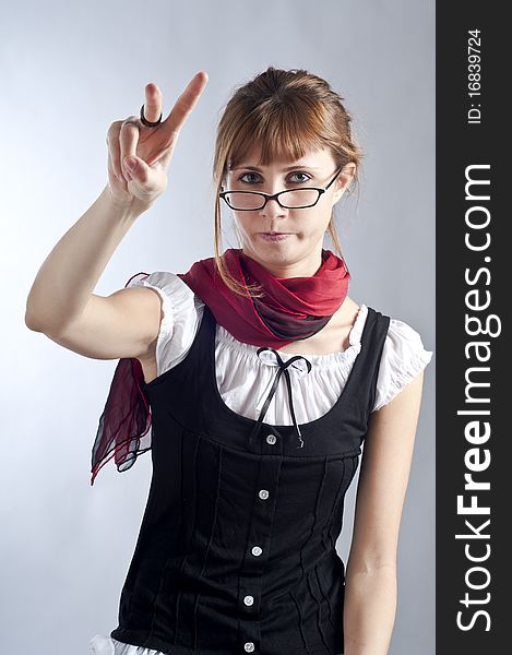 Blonde girl with glasses, pen and book that makes a teacher