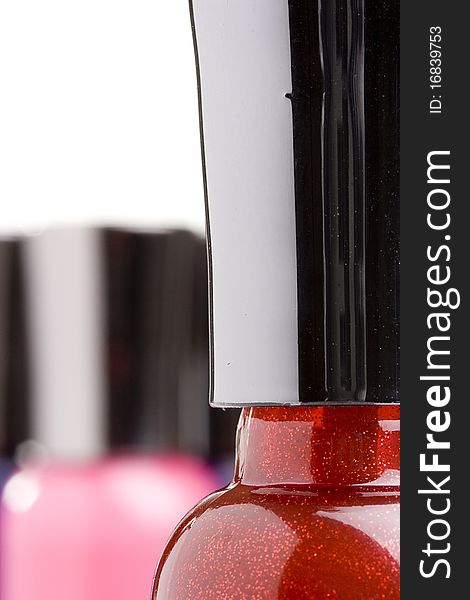 Red nail polish bottle with a black cap.