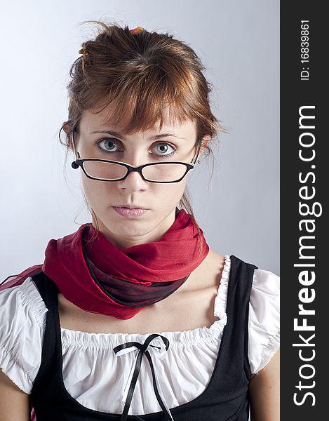 Blonde girl with glasses, pen and book that makes a teacher