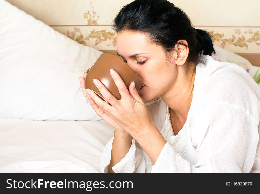 A young woman drinking coffee