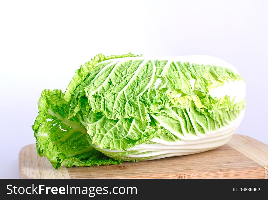 Fresh cabbage on the wood desk isolated on the white background