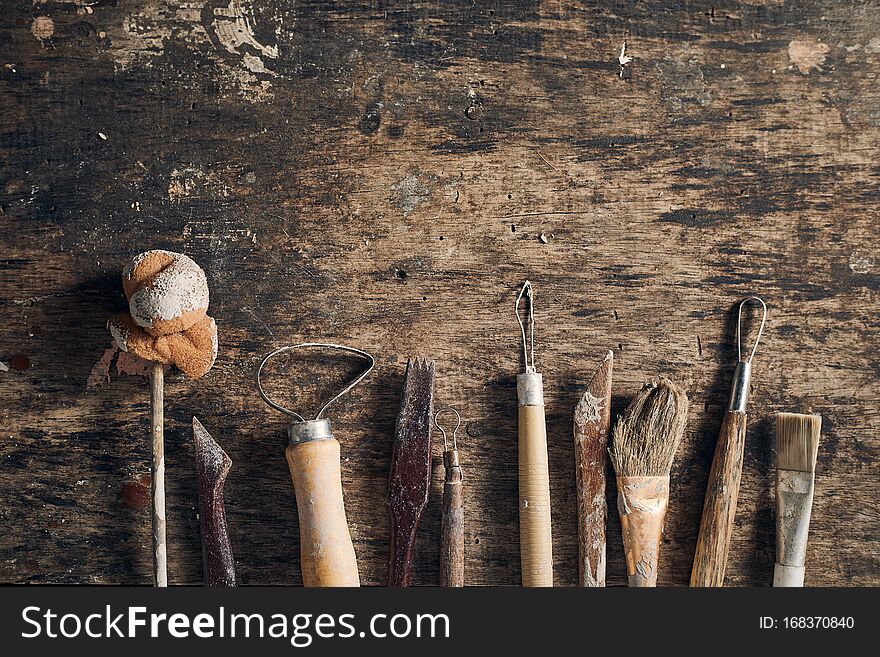 Tools for forming clay on  wooden background. Tools for forming clay on  wooden background