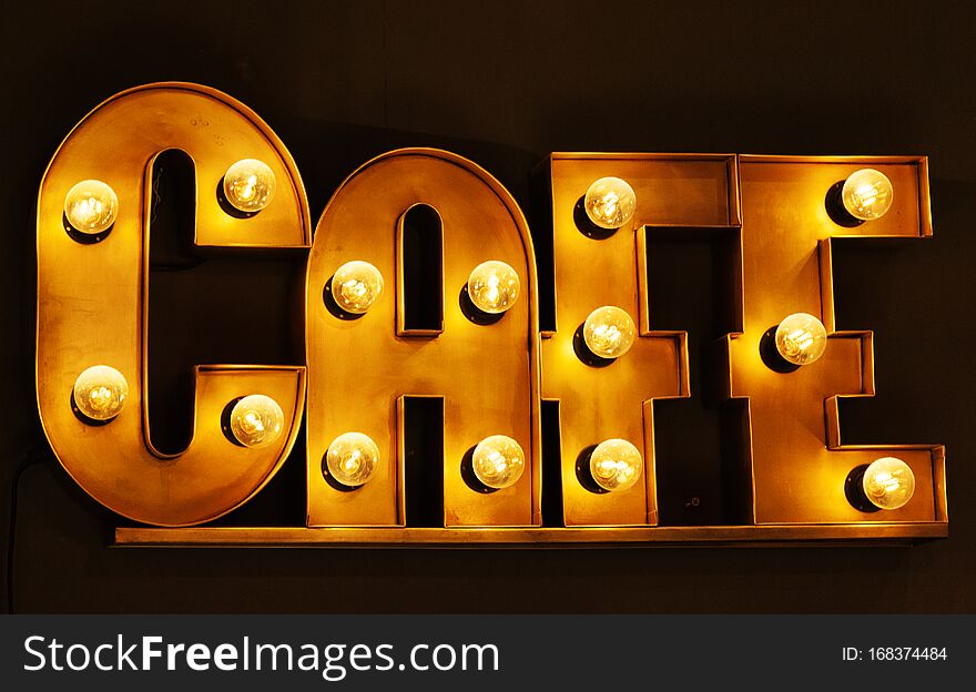 Cafe sign glowing with incandescent lights