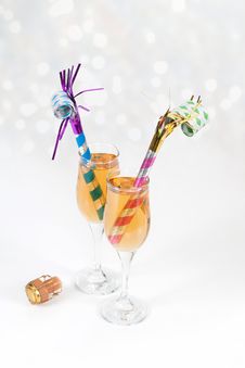 Noisemakers In Two Glasses Of Champagne With Cork Royalty Free Stock Photography Noisemakers In Two Glasses Of Champagne With Cork Royalty Free Stock Photography