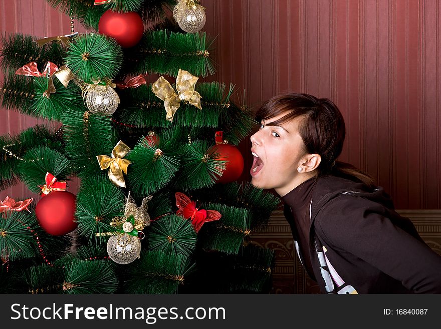 Funny girl near the Christmas tree. Funny girl near the Christmas tree