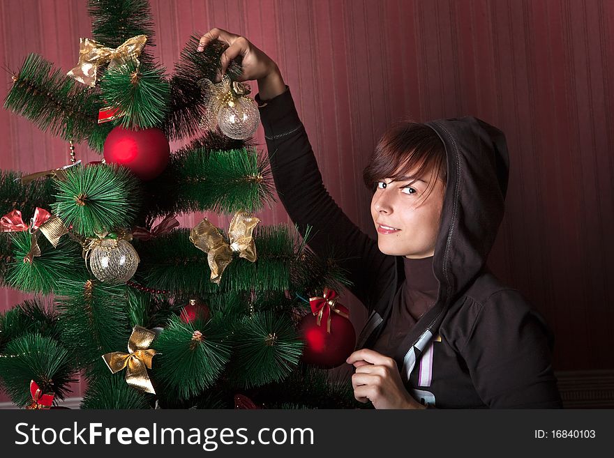 Funny girl decorates the Christmas tree