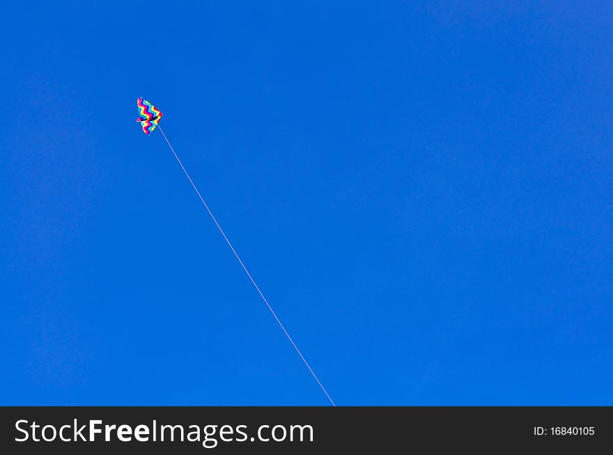Colorful kite on blue sky