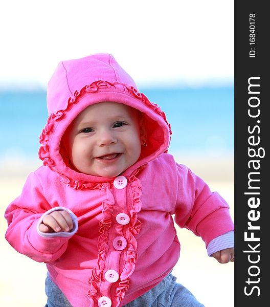 Happy baby girl with pink jacket smiling. Happy baby girl with pink jacket smiling