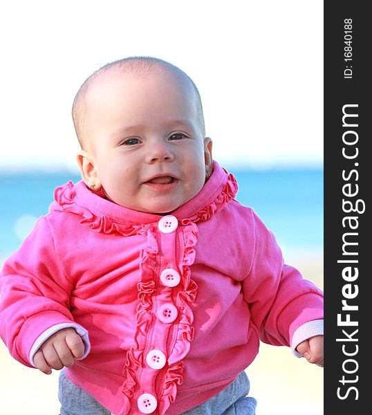 Happy baby girl with pink jacket smiling. Happy baby girl with pink jacket smiling