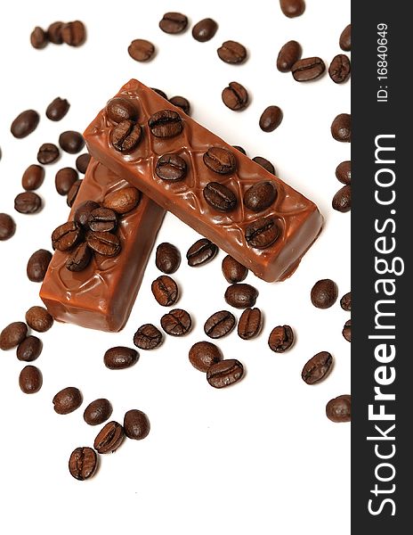 Coffee beans and chocolate on white background. Coffee beans and chocolate on white background