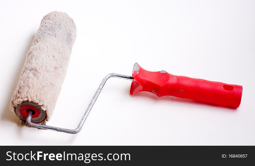 Isolated used paint roller on a white background