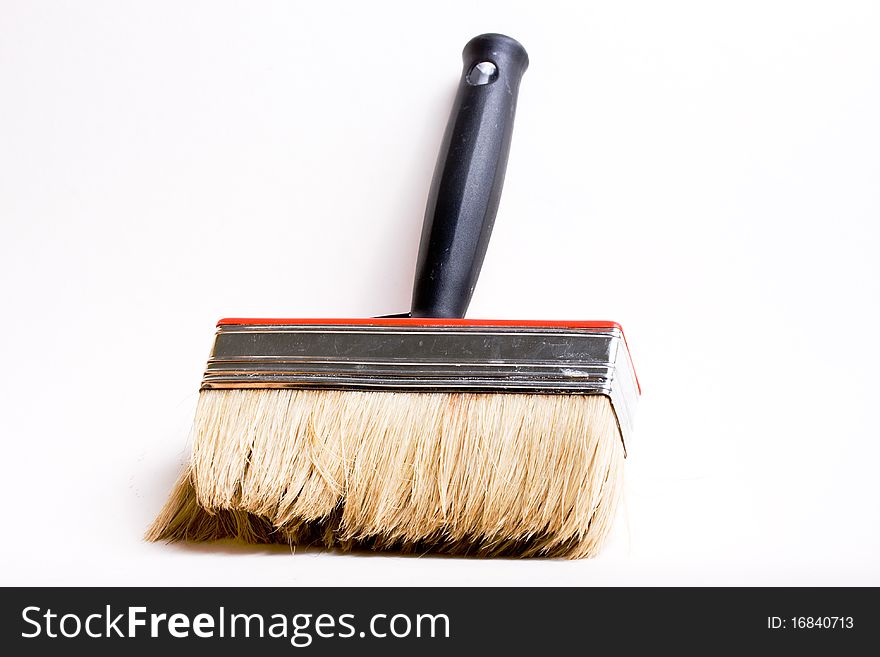 Red paint brush on a white background