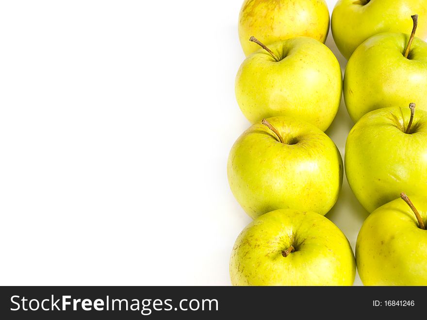 Two vertical raws of green apples on a white background