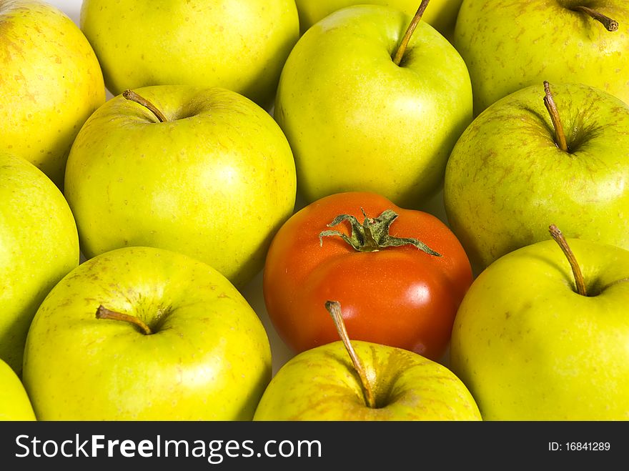 Red ripe tomatoes lying in green apples. Red ripe tomatoes lying in green apples