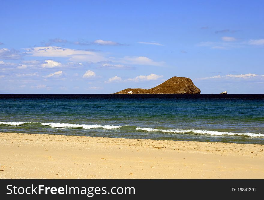 A beautiful and isolated island in the deep blue waters captured off the coast of Spain. A beautiful and isolated island in the deep blue waters captured off the coast of Spain.