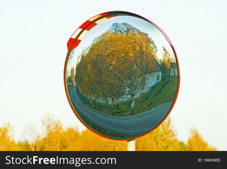 Mirror near road in which the reflects autumn landscape. Mirror near road in which the reflects autumn landscape.