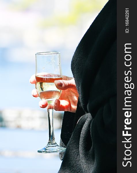 Female hand holding a glass of wine