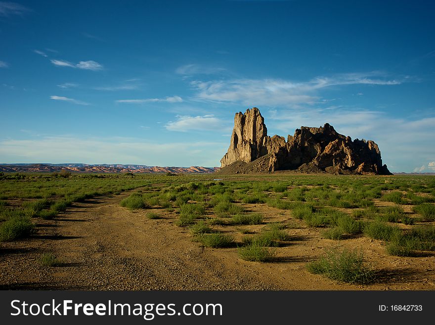 Dirt road leading to a rocky promontory in the northern Arizona desert. Dirt road leading to a rocky promontory in the northern Arizona desert.