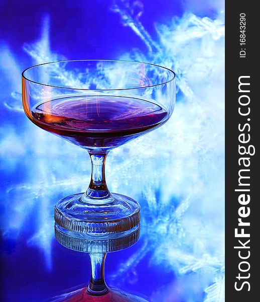 Glass of Cognac isolated on blue background