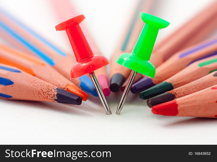 Closeup photo of pencils and pins on white. Closeup photo of pencils and pins on white