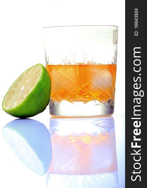 Whiskey glass with lemon with white background.