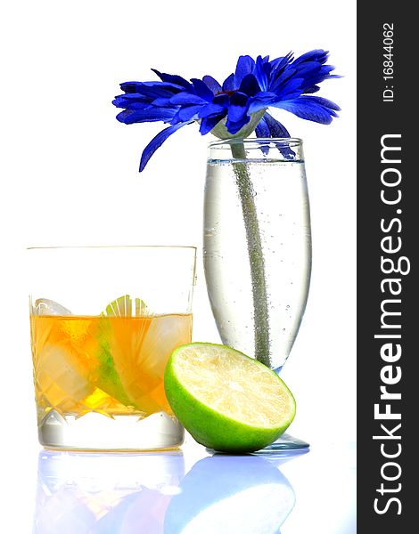 Tropical whiskey glass with lime on white background.