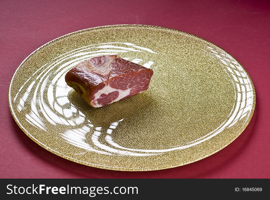 Raw meat on a plate over color background