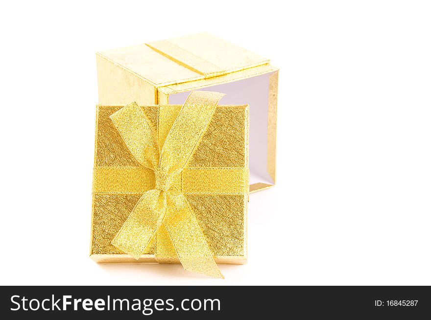 Christmas open giftbox on white background, with golden ribbon. Christmas open giftbox on white background, with golden ribbon