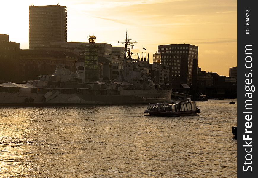 War ship on river thames at sunset in london